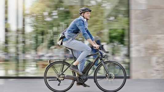 a man riding an electric bike through the city