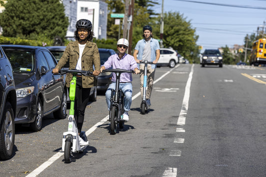 electric scooter and electric bike riders enjoying riding through the city on the bike lane