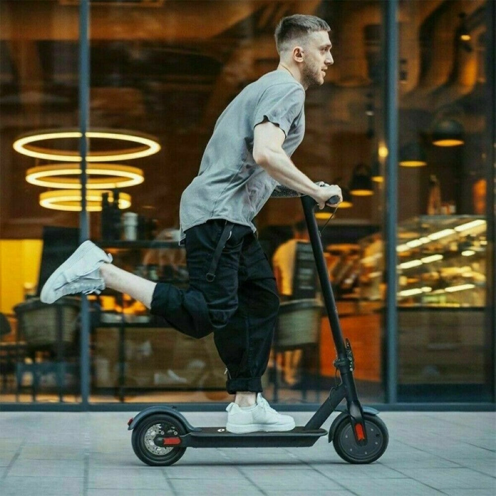 man enjoying riding an electric scooter outside