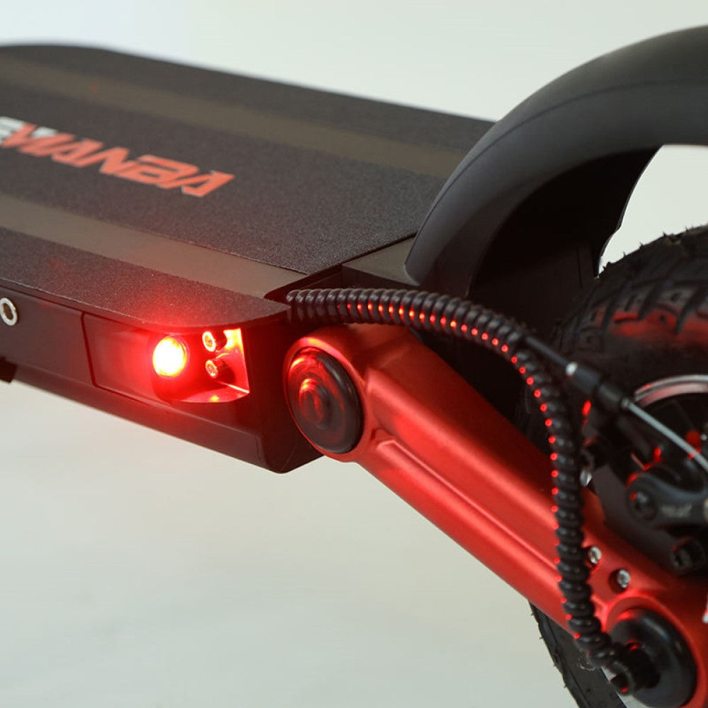up-close view of rear wheel taillight of an off-road electric scooter
